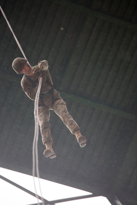A U.S. Marine executes an Australian-style helicopter rappel March 20 during the final day of the three-day Mountain Warfare Training Course at the Mountain Warfare Training Center in Pohang, Republic of Korea. Australian rappelling is a military assault technique where the Marine rappels face down allowing them to fire a weapon. The U.S. Marines taking part in the course are with III Marine Expeditionary Force and are in the Republic of Korea to take part in Marine Expeditionary Force Exercise 2014. MEFEX 14 exercises the interoperability and combined capabilities of the ROK and U.S. Marine Corps.. (U.S. Marine Corps photo by Lance Cpl. Cedric R. Haller II/RELEASED)