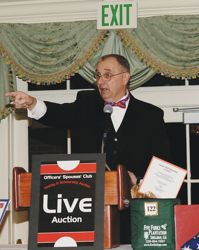 Kent Morrison, Marine Corps Logistics Base Albany's executive director, acts as the auctioneer for the Officers Spouses' Club auction, Feb. 15, at the Doublegate Country Club in Albany, Ga.