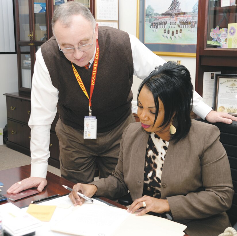 Kent Morrison, Marine Corps Logistics Base Albany’s executive director, reviews documents with Laura A. Thorne, executive assistant to the commanding officer, Marine Corps Logistics Base Albany, recently. 