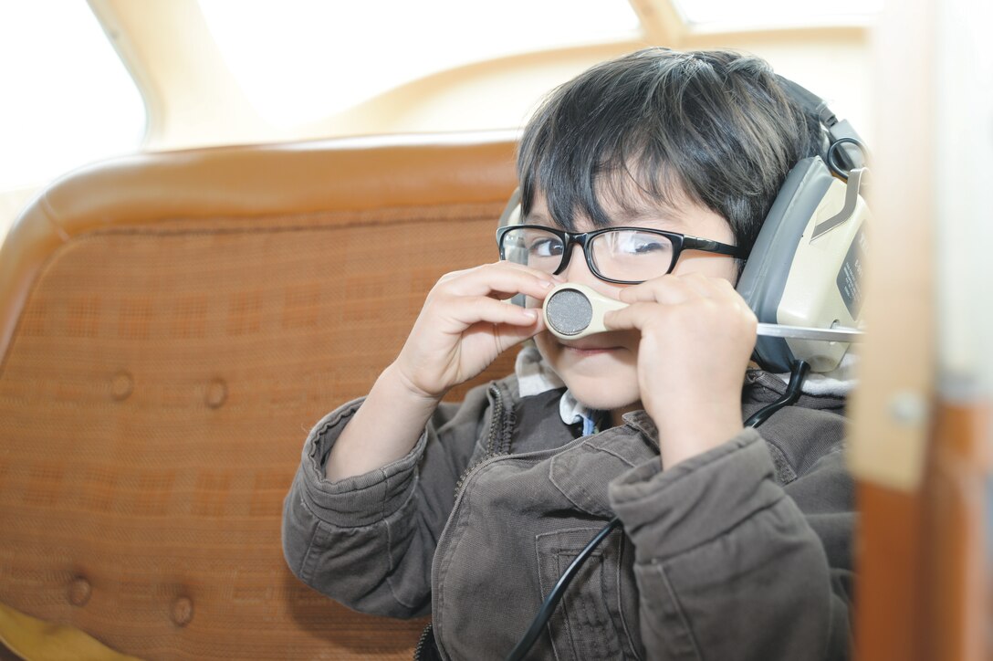 A young prospective aviator adjusts the mouthpiece prior to his flight at the Southwest Georgia Regional Airport in Albany, Ga., Saturday.