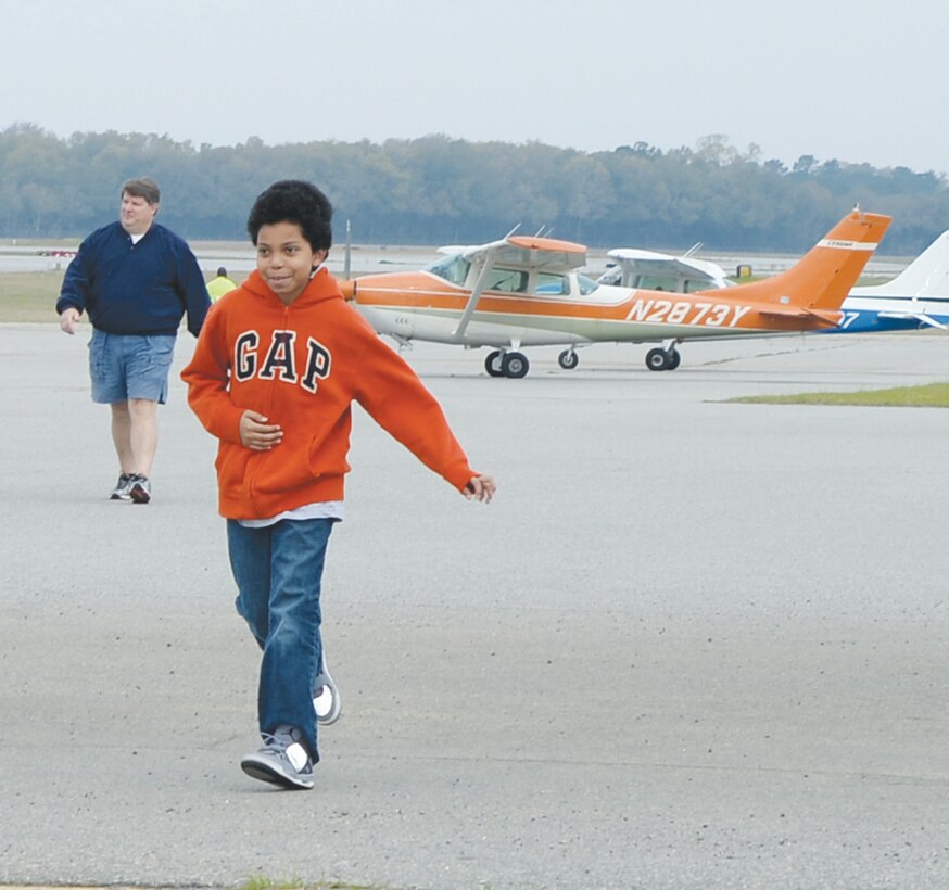 A happy child returns to a hanger after his flight compliments of the Civil Air Patrol at Southwest Georgia Regional Airport in Albany Ga., Saturday.