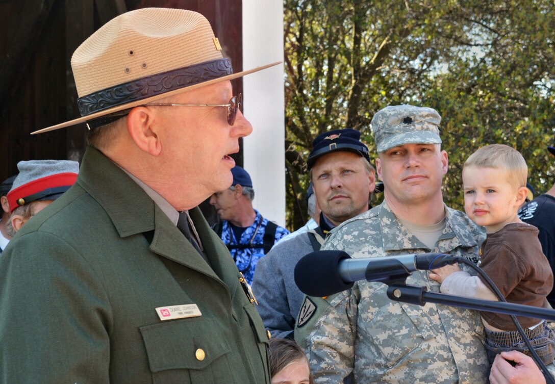 Duane Johnson, park manager for the U.S. Army Corps of Engineers Sacramento District’s Stanislaus River Parks (left), speaks about the historic Knights Ferry covered bridge in Knights Ferry, Calif., March 22, 2014, as contracting team leader, Lt. Col. Chris Tande and his son, Gerrit, look on. Sacramento District employees and hundreds of history buffs gathered in Knights Ferry to officially commemorate attaining National Historic Landmark status for the 300-foot-long covered bridge in the historic 19th-century township.