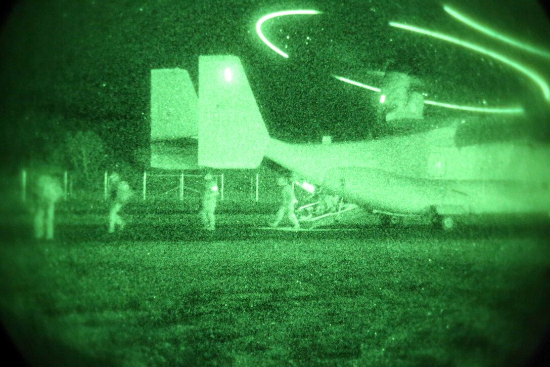 Marines with Weapons Company, Battalion Landing Team 2nd Battalion, 1st Marines (BLT 2/1), 11th Marine Expeditionary Unit, unload from an MV-22 Osprey after succesfully completing a tactical recovery of aircraft and personnel (TRAP) mission during Realistic Urban Training Marine Expeditionary Unit Exercise 14-1 (RUTMEUEX) at Fort Hunter Liggett, Calif., March 27, 2014.  RUTMEUEX will prepare the 11th MEU Marines for their upcoming deployment, enhancing Marines' combat skills in environments similar to those they may find in future missions.  (U.S. Marine Corps photo by Lance Cpl. Evan R. White/Released)