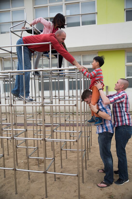 U.S. Marines help a student climb a jungle gym March 25 during a community relations event at the Haneulggum Ji Yeok Adong Center in Pohang, Republic of Korea. The Marines volunteered to go to the center to teach the students English through playful interaction. The U.S. Marines are with 7th Communication Battalion, III Marine Expeditionary Force Headquarters Group, III MEF, and are in ROK in support of exercise Ssang Yong, which is an exercise intended to strengthen ROK and U.S. combat readiness and combined interoperability and advance the ROK Marine Corps Marine Task Force and command and control capabilities through the conduct of combined amphibious operations. (U.S. Marine Corps photo by Lance Cpl. Cedric R. Haller II/RELEASED)
