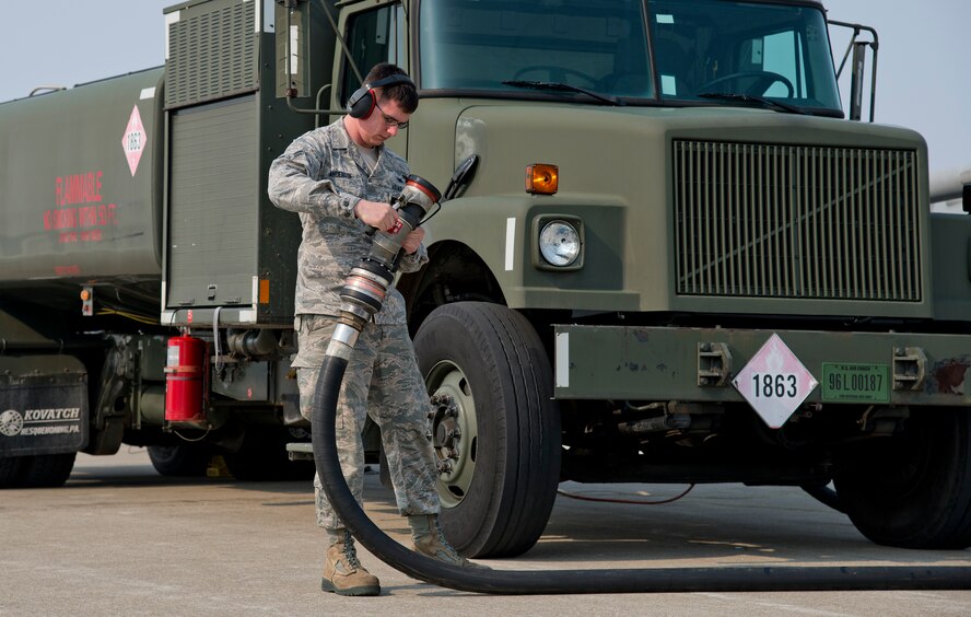 U.S. Air Force Airman 1st Class Sabastian Anderson reels in a fuel pump after successfully refueling an F-16 Fighting Falcon at Misawa Air Base, Japan, March 25, 2014. With refueling completed, Anderson and his crew retract the fuel pump from the aircraft and allow the jet to get back to the fight. (U.S. Air Force photo/Airman 1st Class Patrick S. Ciccarone)