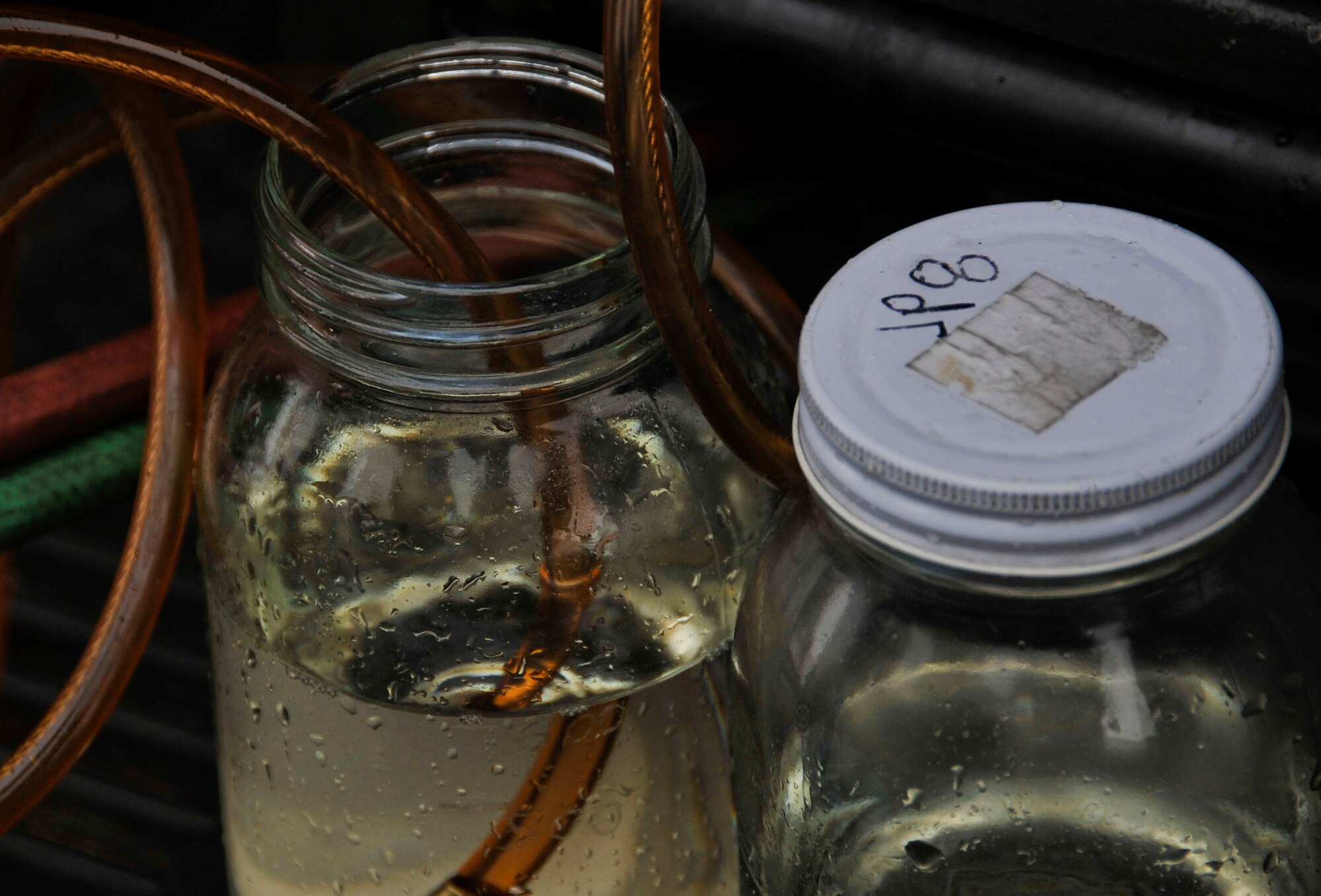 JP-8 fuel is siphoned from a truck into glass containers at Misawa Air Base, Japan, March 25, 2014. The fuel is transported to the 35th Logistics Readiness Squadrons fuel laboratory where it is tested for quality and examined for impurities. (U.S. Air Force photo/Airman 1st Class Patrick S. Ciccarone)