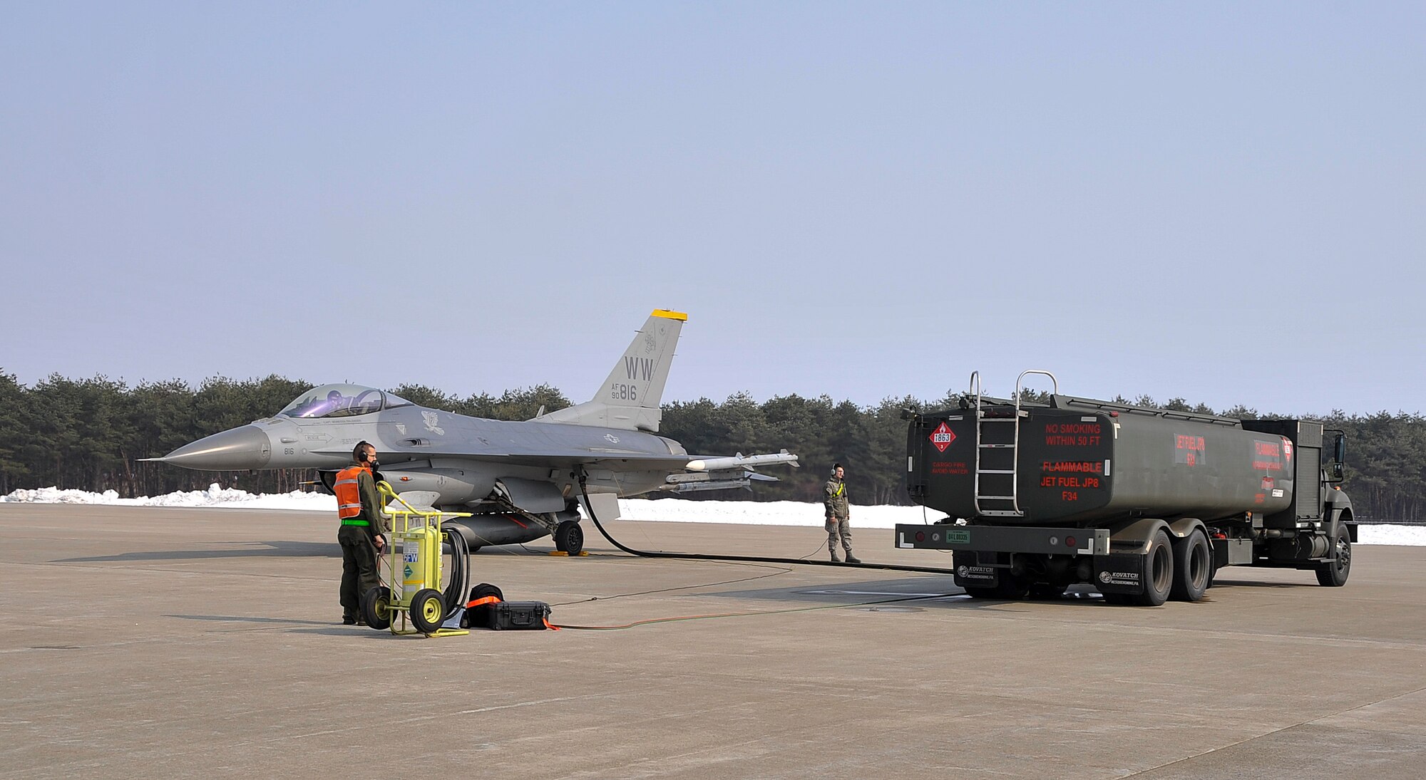 A member of the 35th Logistics Readiness Squadron fuels management flight conducts a hot pit refueling on an F-16 Fighting Falcon at Misawa Air Base, Japan, March 25, 2014. During the refueling process, the 35th Logistics Readiness Squadron fuels management flight Airmen transfer up to 1,500 gallons of JP-8 fuel into each aircraft depending on how many sorties it has flown during the day. (U.S. Air Force photo/Airman 1st Class Patrick S. Ciccarone)