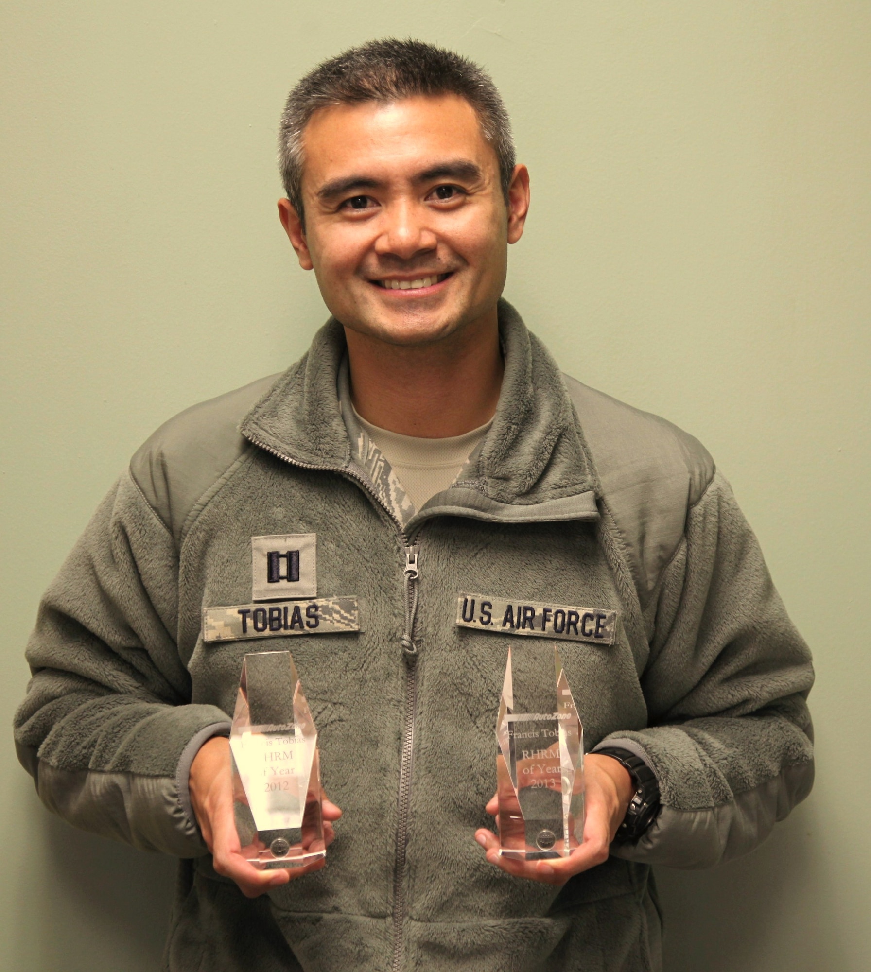 Capt. Francis Tobias, 940th Wing Equal Opportunity Director, displays trophies recognizing the reservist as Autozone's Regional Human Resources Manager of the Year for 2012 and 2013. Tobias credits his family and faith as the foundation for continued success in both his civilian and reserve careers. (U.S. Air Force photo / Senior Airman Adam Hamar) 