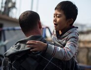 Staff Sgt. Matthew Folendore, 51st Comptroller Squadron noncommissioned officer in charge of relocations at Osan Air Base, Republic of Korea, holds an orphan March 22, 2014, at the Aehyang Child Welfare Center in Pyeongtaek. Volunteers said they enjoyed playing with the children, and were taught a lot by doing so. (U.S. Air Force photo by Staff Sgt. Jake Barreiro)