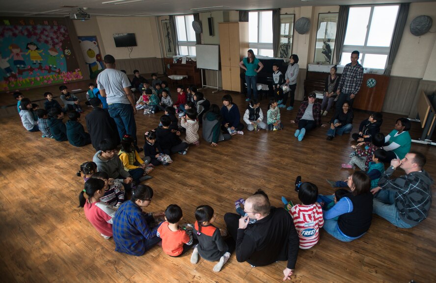 Airmen from the 51st Fighter Wing Staff Agencies at Osan Air Base, Republic of Korea, play duck, duck, goose with orphans March 22, 2014, at the Aehyang Child Welfare Center in Pyeongtaek. Airmen from Osan AB routinely volunteer at the orphanage. (U.S. Air Force photo by Staff Sgt. Jake Barreiro)