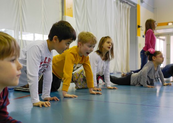 Yokota West elementary students do push-ups on March 20, 2014, at Yokota Air Base, Japan.  The students were part of the 10-week-long fitness program Club 2-1-5-0.  The program aims to reduce childhood obesity through healthy diet and ample physical activity.  (U.S. Air Force photo by Airman 1st Class Soo C. Kim / Released)