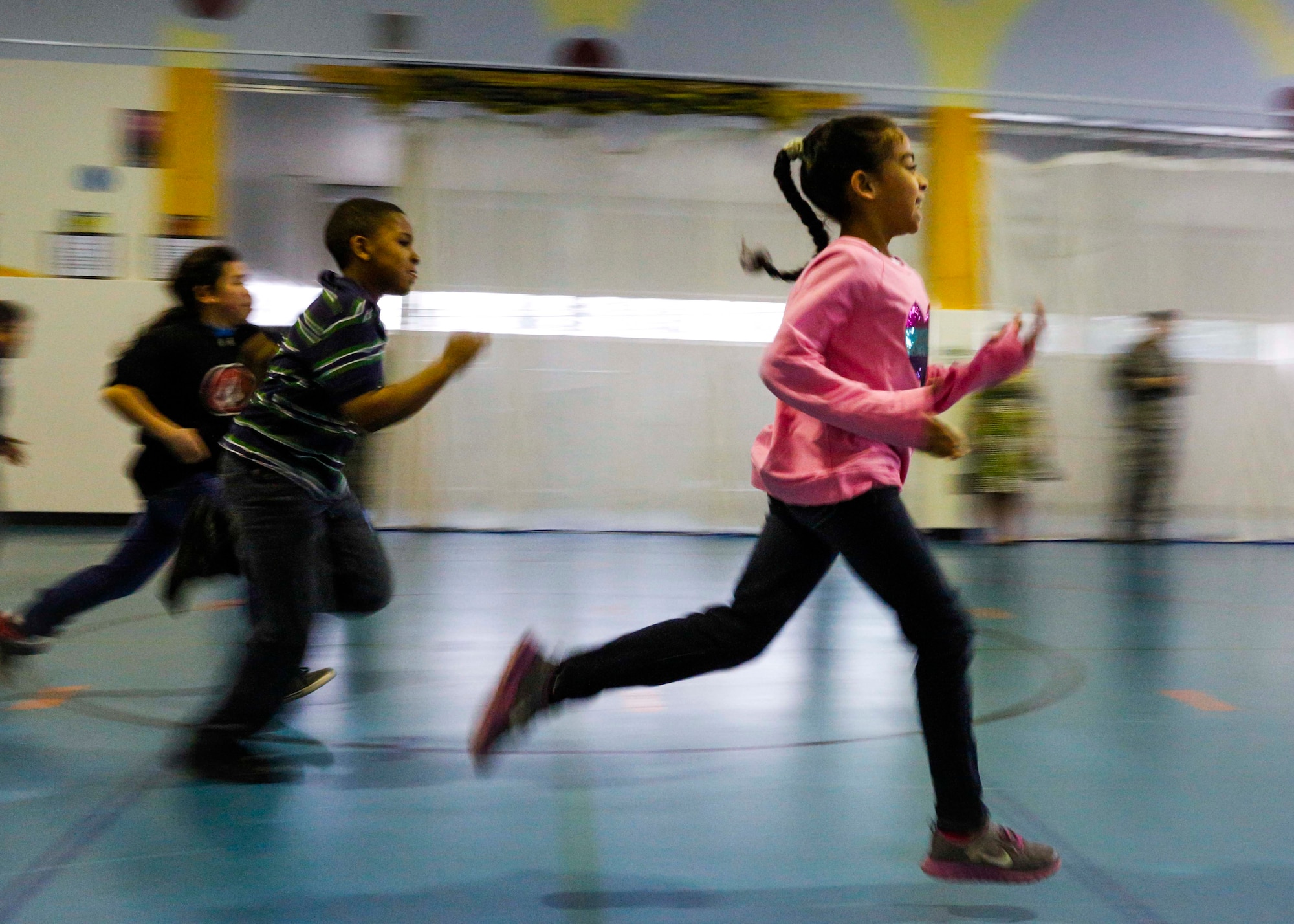 Yokota West elementary students run during the physical assessment of Club 2-1-5-0 post-biometrics on March 20, 2014, at Yokota Air Base, Japan.  During the 10-week-long assessment, students were taught various games and sports to ensure they kept physically active.  (U.S. Air Force photo by Airman 1st Class Soo C. Kim / Released)