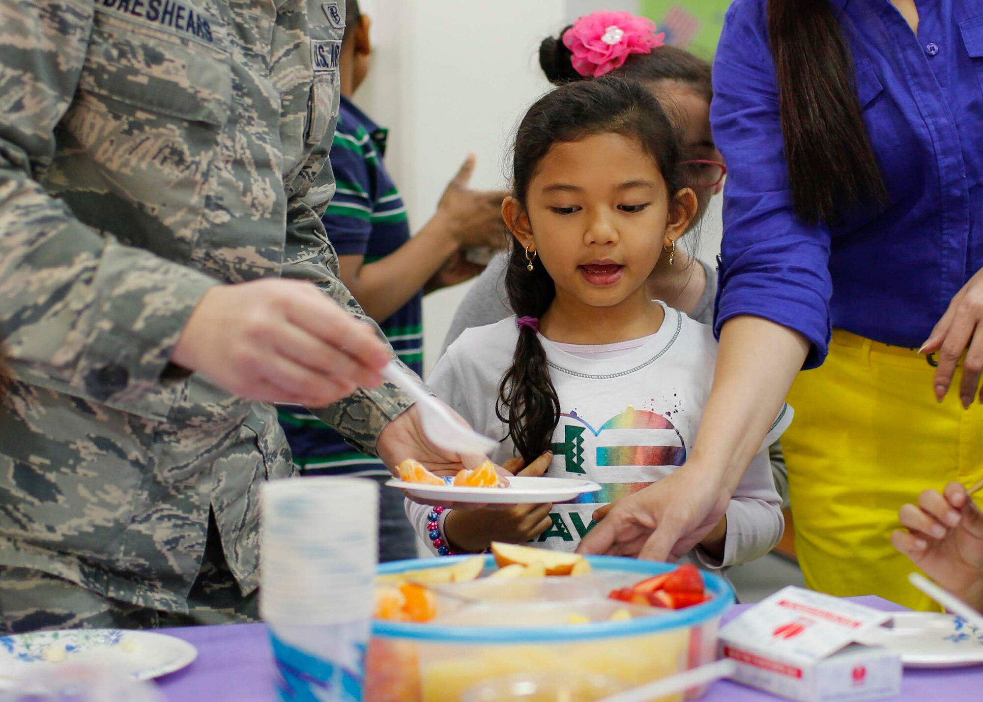 Yokota West elementary student receives a plate of fruit during the last day of the Club 2-1-5-0 assessment on March 20, 2014, at Yokota Air Base, Japan.  Club 2-1-5-0 aims to reduce childhood obesity by promoting healthy diet, and ample physical activity.  (U.S. Air Force photo by Airman 1st Class Soo C. Kim / Released)