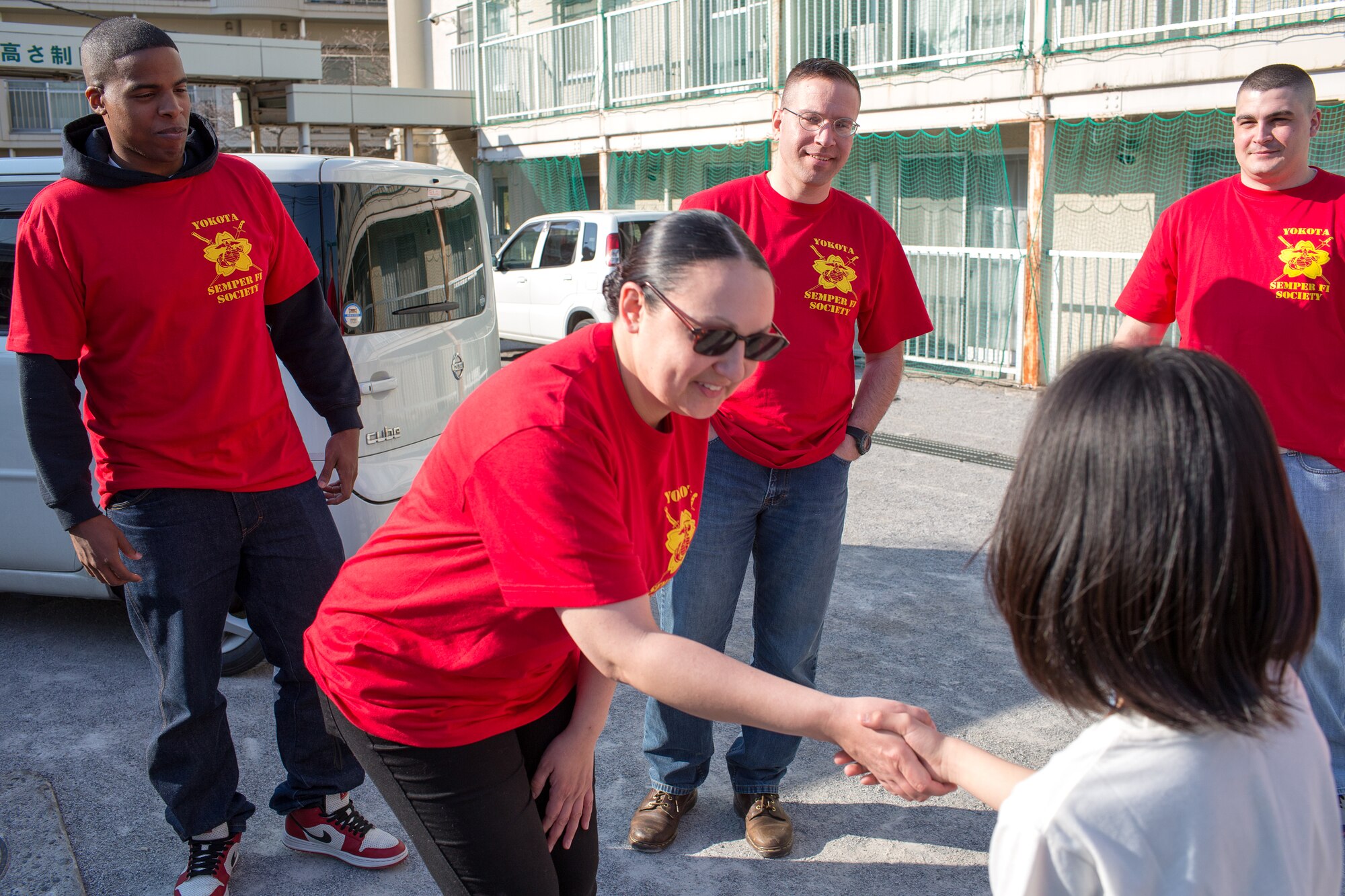 Gunnery Sgt. Tiffany Carter, U.S. Forces Japan, shakes hands with a child
at Ajiro orphanage in Akiruno City, Tokyo, March 24, 2014, during the annual Semper Fi Society’s toy drop. The SFS is comprised of active duty Marines, former Marines, and additional volunteers. (U.S. Air Force photo by Osakabe Yasuo/Released)
