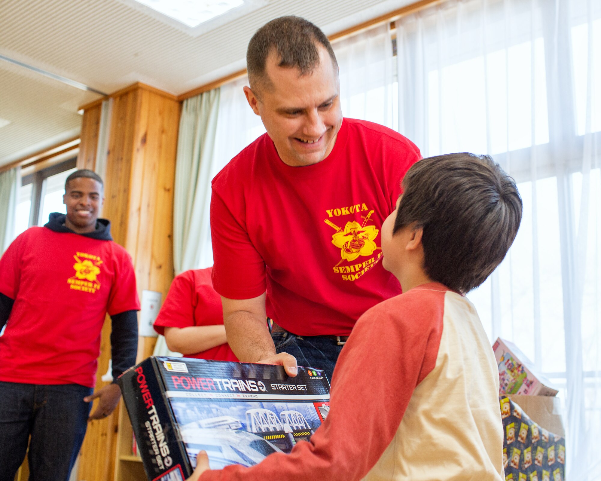 Marine Major Fred Ingo, U.S. Forces Japan, presents a child with a toy at Ajiro
orphanage in Akiruno city, Tokyo, March 24, 2014, during the annual Semper Fi Society’s toy drop. The SFS at Yokota delivered more than 200 toys to the orphanage. (U.S. Air Force photo by Osakabe Yasuo/Released)
