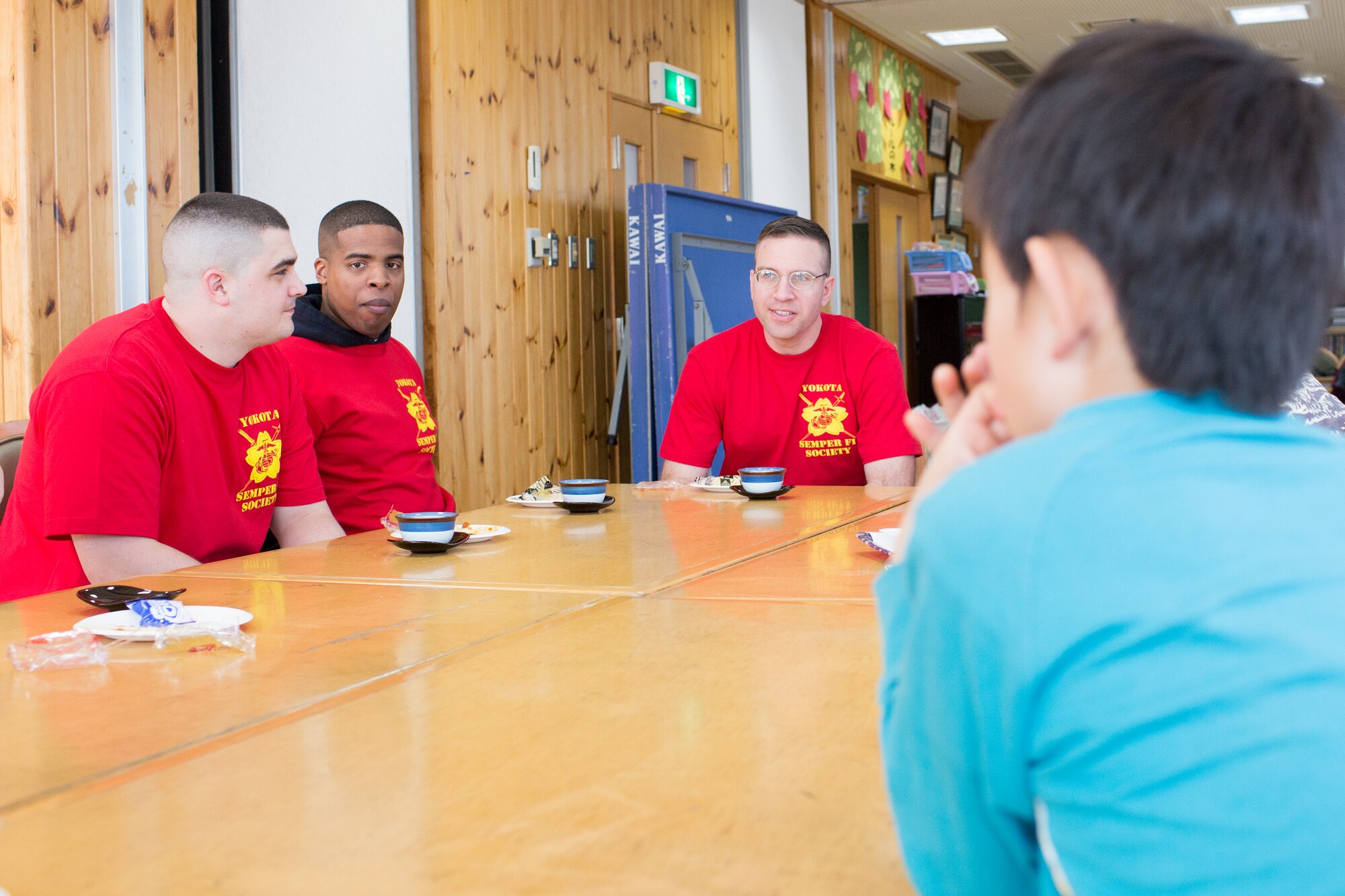 Marines from Yokota Air Base are offered a cup of Japanese tea at the Ajiro orphanage in Akiruno city, Tokyo, Japan, March 24, 2014, during the annual Semper Fi Society’s toy drop. The SFS is comprised of active duty Marines, former Marines, and additional volunteers. (U.S. Air Force photo by Osakabe Yasuo/Released)