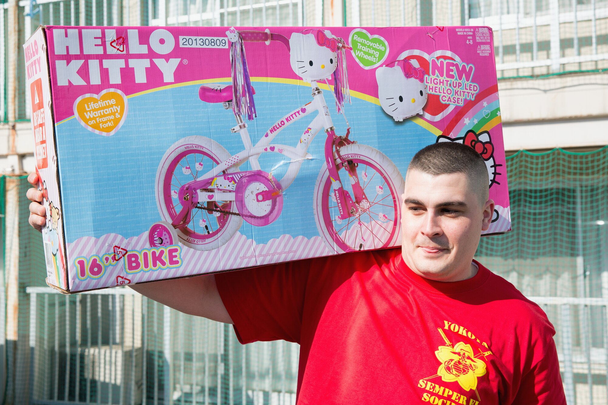 Marine Sgt. Jeremiah Crane, U.S. Forces Japan, carries a toy to the Ajiro orphanage
in Akiruno city, Tokyo, Japan, March 24, 2014, during the annual Semper Fi Society’s toy drop. Since 2012, Semper Fi Society has collected toys from “Toys for Tots” drives at Yokota Air Base and distributes them in the local Japanese community. (U.S. Air Force photo by Osakabe Yasuo/Released)
