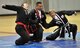 Retired Master Sgt. Amado Garcia, previously assigned to the 96th Aircraft Maintenance Squadron Eglin Air Force Base, Fla., disables two opponents with a joint lock technique during a Kuk Sool Won Black Belt Demo at the Aderholt Fitness Center on Hurlburt Field, Fla, March 22, 2014. Students of Kuk Sool Won learn restraining methods, joint-breaking and combination joint locking techniques. (U.S. Air Force photo/Senior Airman Kentavist P. Brackin) 