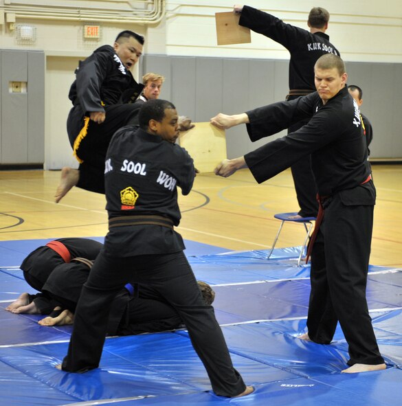 Sherwin Huegin executes a flying kick at a wooden board during a Kuk Sool Won Black Belt Demo at the Aderholt Fitness Center on Hurlburt Field, Fla, March 23, 2014. Huegin was one of two students promoted to 1st degree black belt during the demo. (U.S. Air Force photo/Senior Airman Kentavist P. Brackin) 