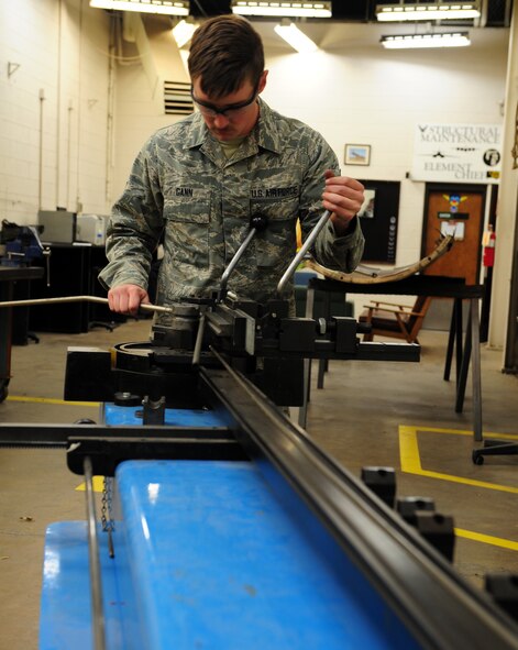 U.S. Air Force Senior Airman Tyler Gann, 7th Equipment Maintenance Squadron aircraft structural maintenance, bends a titanium tube March 26, 2014, at Dyess Air Force Base, Texas. If the replacement tube isn’t manufactured to the right shape, it may not be able to withstand mass amounts of pressure, which could be detrimental to the aircraft. (U.S. Air Force photo by Senior Airman Kia Atkins/Released)