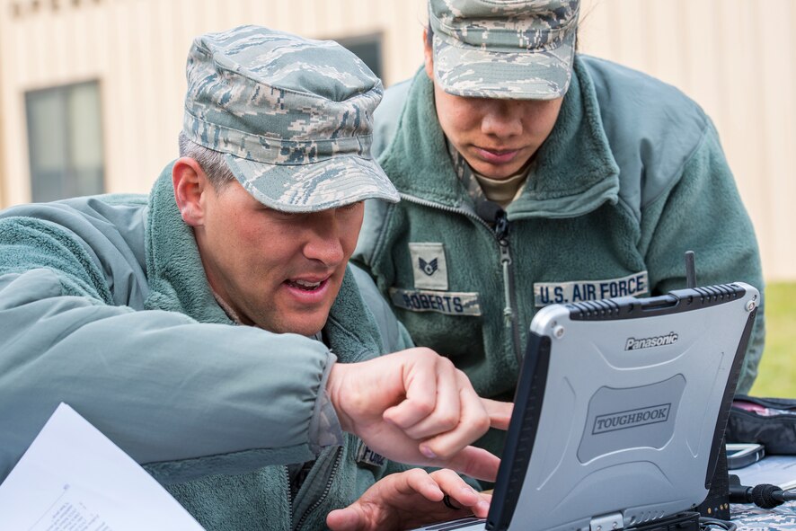 U.S. Air Force Tech. Sgt. Cory Hebb, left, 820th Base Defense Group NCO in charge of Innovative Combat Equipment, and Staff Sgt. Rodshede Roberts, 820th Combat Operations Squadron technologies NCO, locate an RQ-11B Raven via GPS signal at Moody Air Force Base, Ga., March 27, 2014. Moody Airmen have accumulated more than 1000 flight hours on the Raven in the past year. (U.S. Air Force photo by Airman 1st Class Ryan Callaghan/Released)