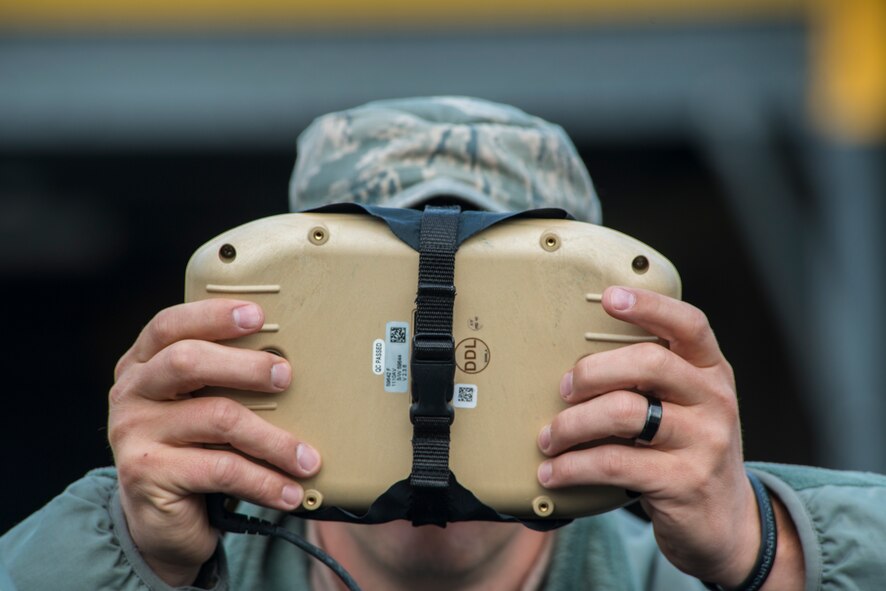 U.S. Air Force Tech. Sgt. Cory Hebb, 820th Base Defense Group NCO in charge of Innovative Combat Equipment, operates a ground control unit while flying an RQ-11B Raven at Moody Air Force Base, Ga., March 27, 2014. The Raven can be flown manually or can navigate a preplanned route autonomously. (U.S. Air Force photo by Airman 1st Class Ryan Callaghan/Released)