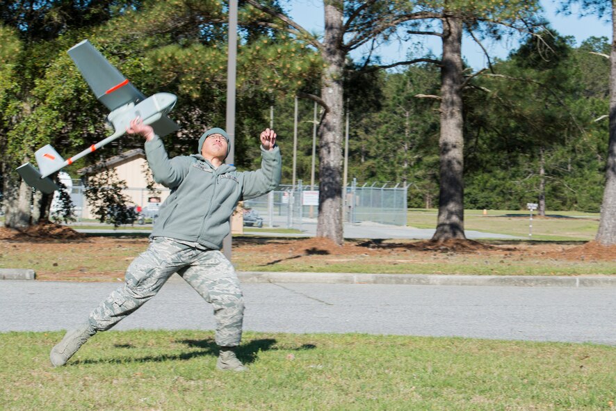 U.S. Air Force Staff Sgt. Andrew Yu, 824th Base Defense Squadron fire team leader, launches an RQ-11B Raven at Moody Air Force Base, Ga., March 26, 2014. The Raven weighs 4.2 pounds and has a wingspan of four and a half feet. It is back-packable and classified as a small unmanned aircraft system. (U.S. Air Force photo by Airman 1st Class Ryan Callaghan/Released)