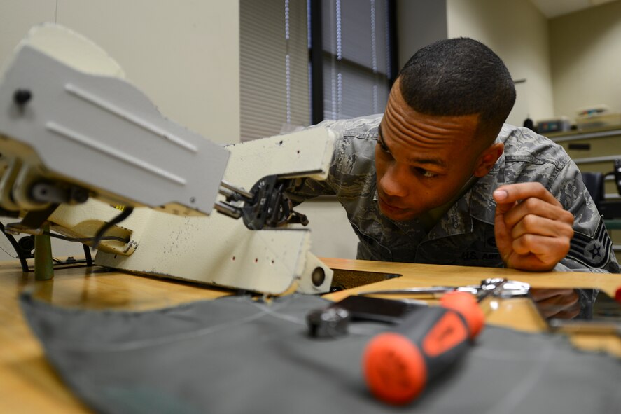 Staff Sgt. Tyron Jones, 22nd Operations Support Squadron aircrew flight equipment craftsman, prepares an industrial sewing machine, March 27, 2014, at McConnell Air Force Base, Kan. AFE Airmen provide stitching maintenance for equipment stored inside KC-135 Stratotankers, such as emergency passenger oxygen systems and F-2B canopy covers. (U.S. Air Force photo/Airman 1st Class John Linzmeier)