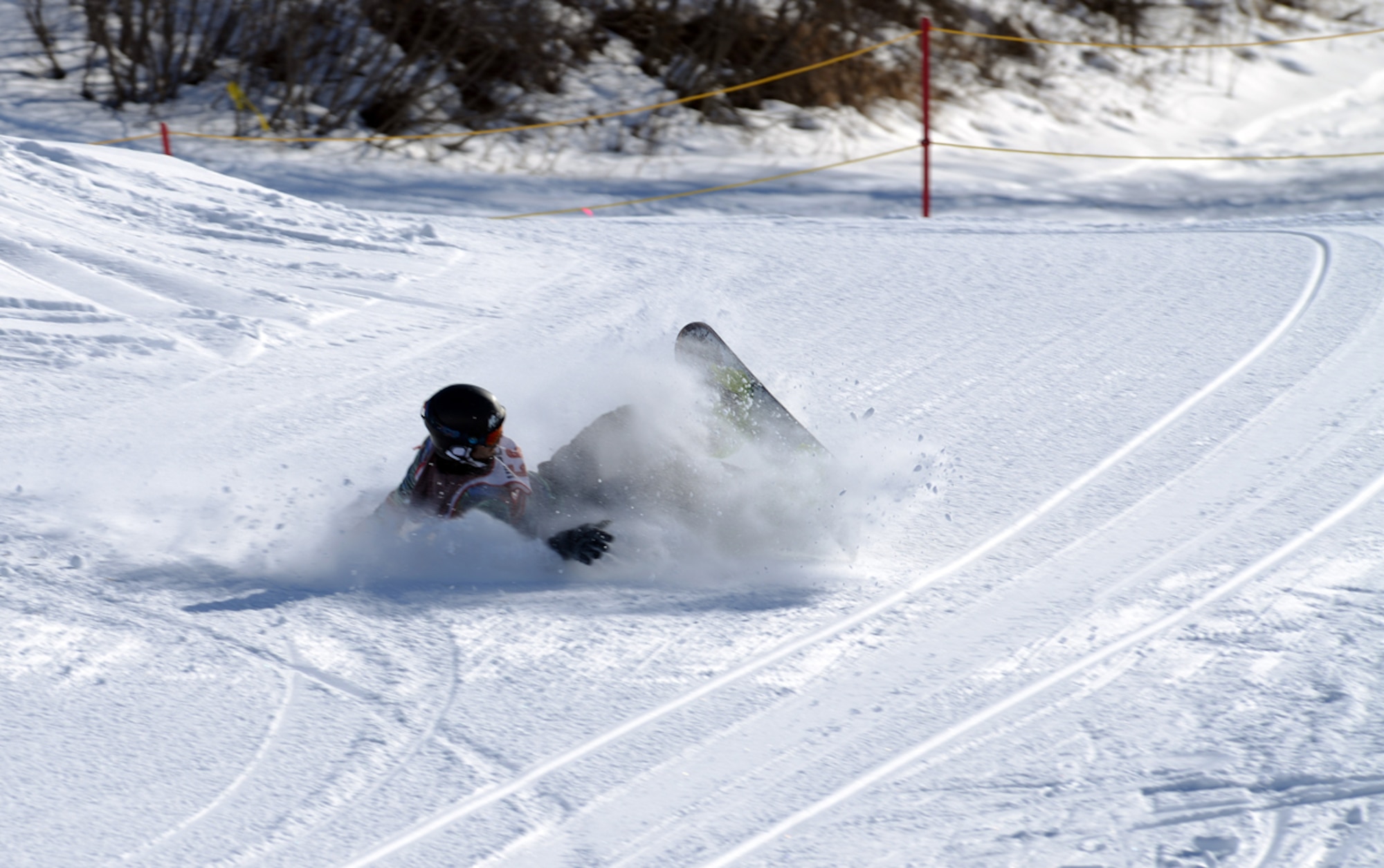 JOINT BASE ELMENDORF-RICHARDSON-- Justin Panter, 20, crashes after attempting a trick at the terrain park competition during the Hillberg Ski Area on Joint Base Elmendorf-Richardson, Alaska, March 22, 2014. The competition included the commanders? bobsled race, a terrain park competition, an up-hill/down-hill race and the Slush Cup competition. Panter took first place in the terrain park competition. (U.S. Air Force photo/Staff Sgt. Sheila deVera)