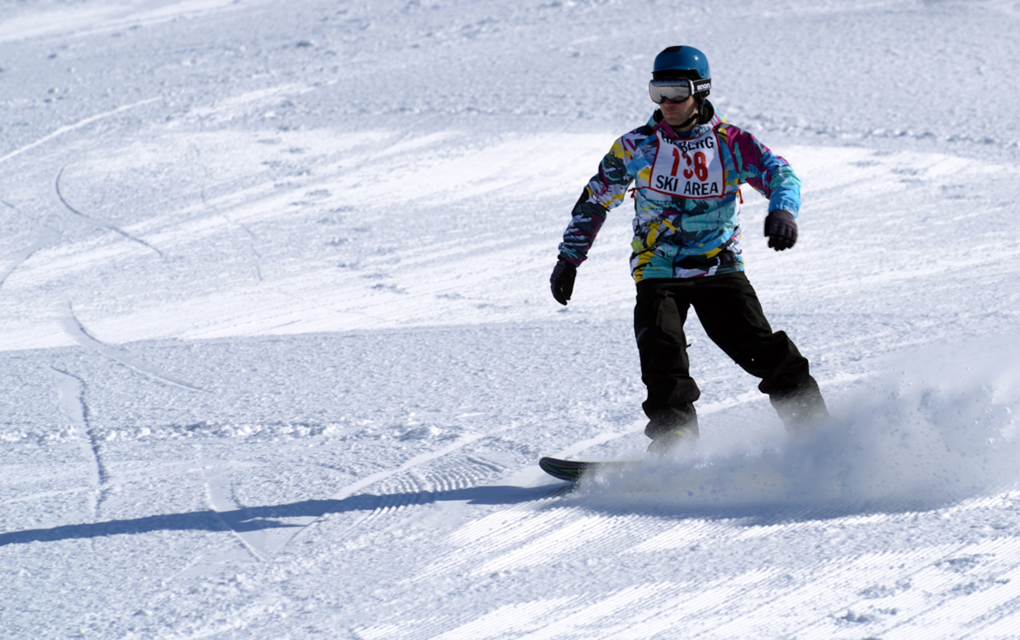 JOINT BASE ELMENDORF-RICHARDSON-- Robert Youmans snowboards down a hill during the 673d Force Support Squadron?s Spring Meltdown event at the Hillberg Ski Area on Joint Base Elmendorf-Richardson, Alaska, March 22, 2014. The event included the commanders? bobsled race, a terrain park competition, an up-hill/down-hill race and the Slush Cup competition. (U.S. Air Force photo/Staff Sgt. Sheila deVera)
