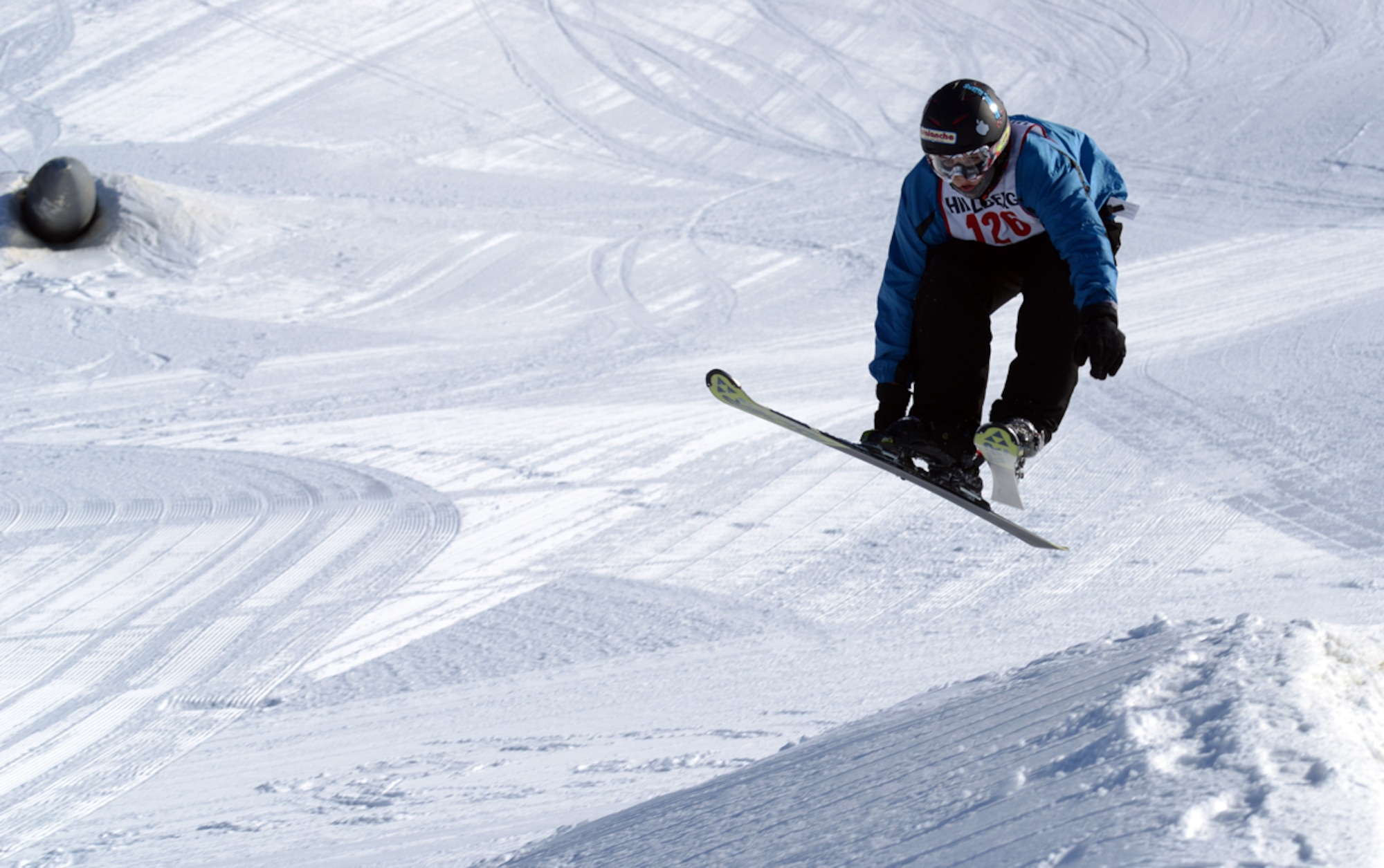JOINT BASE ELMENDORF-RICHARDSON-- Gaven Hollingsworth, 13, jumps over a mogul at the Hillberg Ski Area terrain park during a free style ski competition on Joint Base Elmendorf-Richardson, Alaska, March 22, 2014. The terrain park competition is one of the four events held at Hillberg Ski Area. The Spring Meltdown is an annual two-day event hosted at the beginning of spring.(U.S. Air Force photo/Staff Sgt. Sheila deVera)