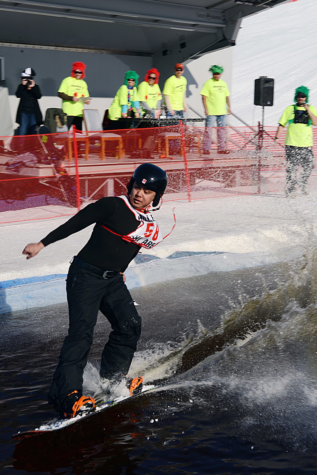 JOINT BASE ELMENDORF-RICHARDSON?Army Spc. Thomas Quartararo, geospatial imagery analyst, snowboards across a man-made pool of water on Joint Base Elmendorf-Richardson, Alaska, March 23, 2014. The Slush Cup is part of the 673d Force Support Squadron?s is Spring Meltdown event. Quantararo is assigned to the 425th Brigade Special Troops Battalion, 4th Infantry Brigade Combat Team (Airborne), 25th Infantry Division. (U.S. Air Force photo/Airman 1st Class Ty-Rico Lea)
