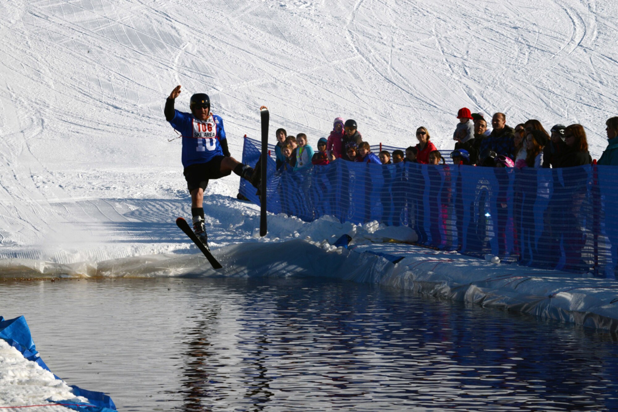JOINT BASE ELMENDORF-RICHARDSON-- Ken Donnolly skis into a man-made pool of water during the Slush Cup on Joint Base Elmendorf-Richardson, Alaska, March 23, 2014. The Slush Cup is part of the Hillberg Ski Area's two-day Spring Meltdown event. More than 43 participants took part in the two-day event. (U.S. Air Force photo/Airman 1st Class Ty-Rico Lea)