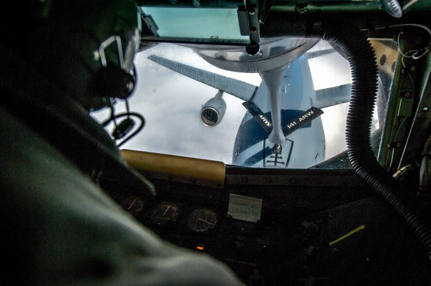 Staff Sgt. Ryan Kiser connects with a KC-10 Extender from Travis Air Force Base, Calif., during an air refueling mission and incentive flight on board a 92nd Air Refueling Wing KC-135 Stratotanker over Oregon and California, March 26, 2014. The KC-135 provides the core aerial refueling capability for the U.S. Air Force and has excelled in this role for more than 50 years. Kiser is a 92nd Air Refueling Squadron boom instructor and a Rancho Cucamonga, Calif., native. (U.S. Air Force photo/Staff Sgt. Benjamin W. Stratton) 

