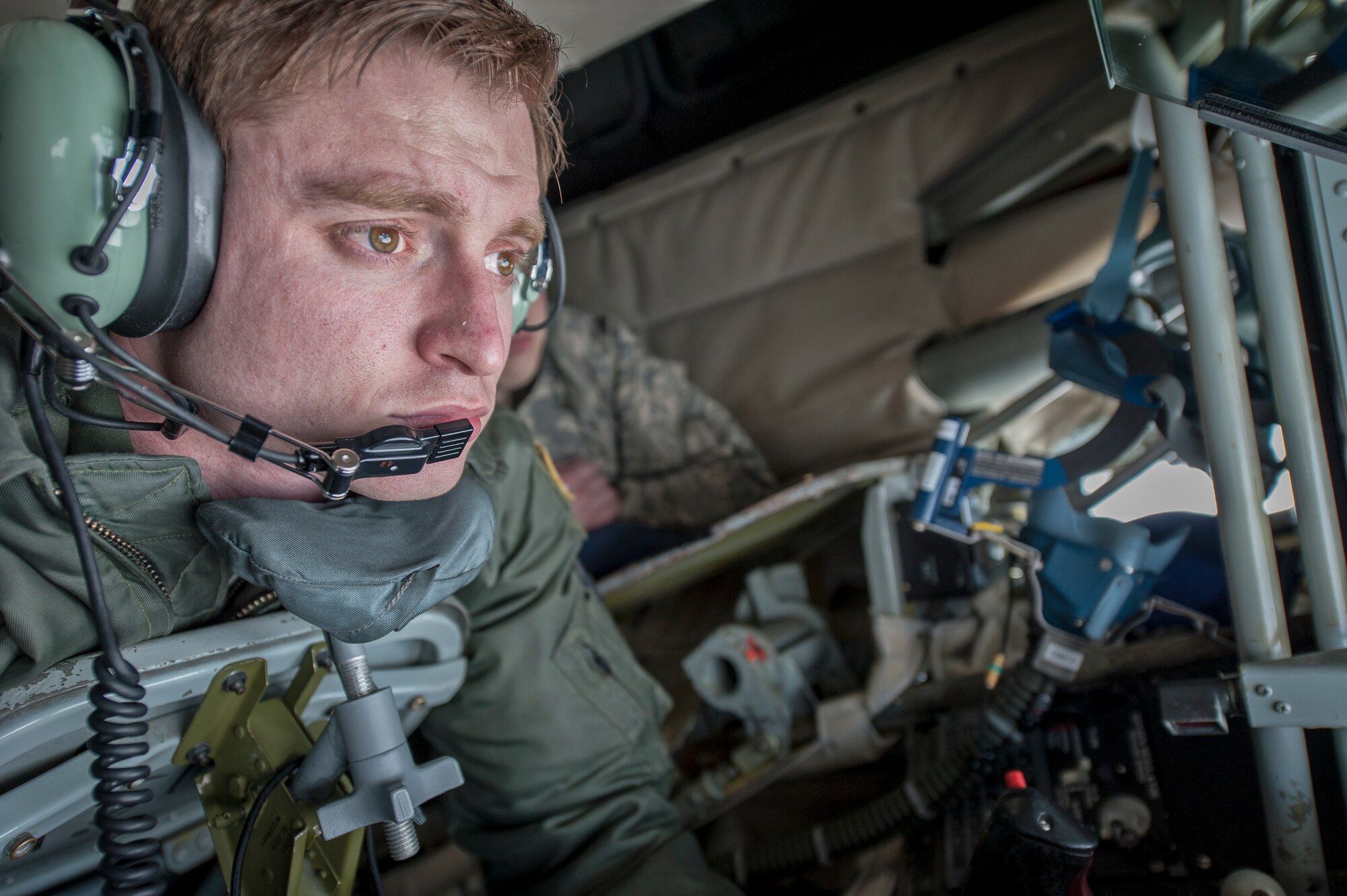 Staff Sgt. Ryan Kiser shows Senior Airman William Forde how he fuels the fight by making a boom connection with a KC-10 Extender from Travis Air Force Base, Calif., during an air refueling mission and incentive flight on board a 92nd Air Refueling Wing KC-135 Stratotanker over Oregon and California, March 26, 2014. Incentive flights are designed as an opportunity for pilots and boom operators to show other Airmen the importance they play in fueling the fight for freedom. Kiser is a 92nd Air Refueling Squadron boom instructor and a Rancho Cucamonga, Calif., native. Forde is a 92nd Contracting Squadron contract specialist and hails from Burien, Wash. (U.S. Air Force photo by Staff Sgt. Benjamin W. Stratton)