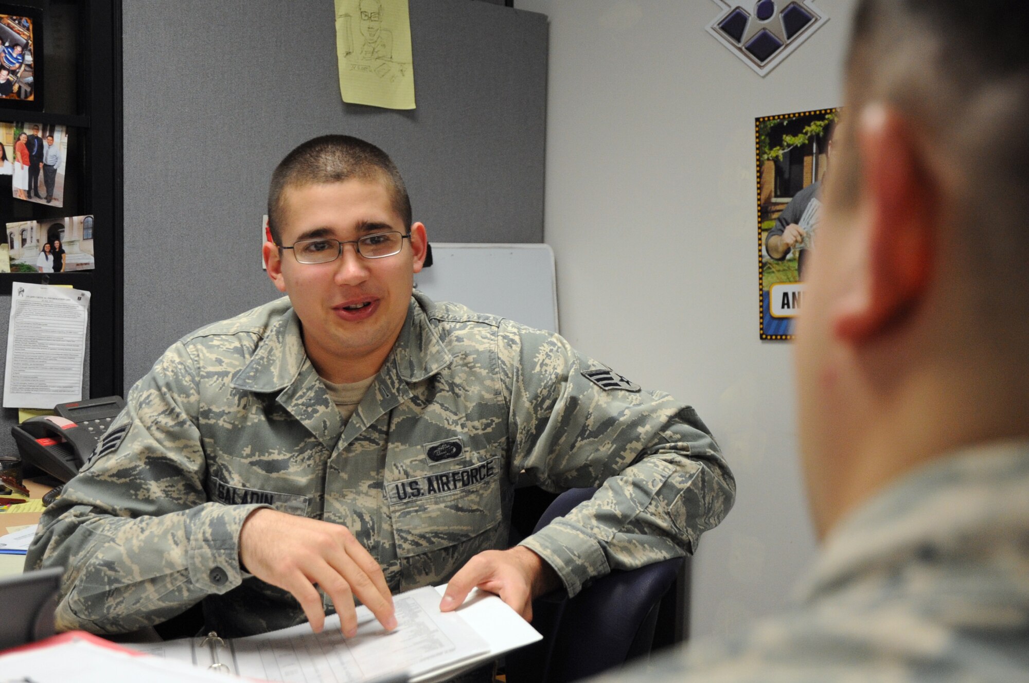 Senior Airman Ryan Saladin, 319th Force Support Squadron career development technician, speaks with a customer regarding his outbound assignment at the Military Personnel Section on Grand Forks Air Force Base, N.D., March 27, 2014. Saladin was selected as the 319th Air Base Wing Warrior of the Week for the final week of March 2014. (U.S. Air Force photo/Staff Sgt. David Dobrydney)