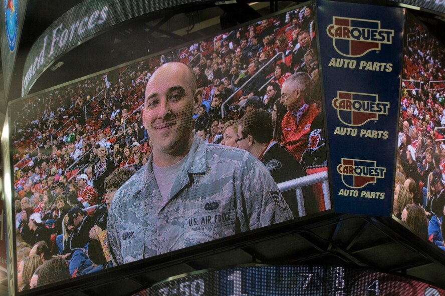 Senior Airman William Harris, 4th Communications Squadron cyber operations technician, is shown on the scoreboard during a hockey game, March 16, 2014, in Raleigh, N.C. Harris was recognized during the Carolina Hurricanes’ Military Appreciation Day game as the 4th Fighter Wing’s Airman of the Year. (U.S. Air Force photo/Airman 1st Class Aaron J. Jenne)