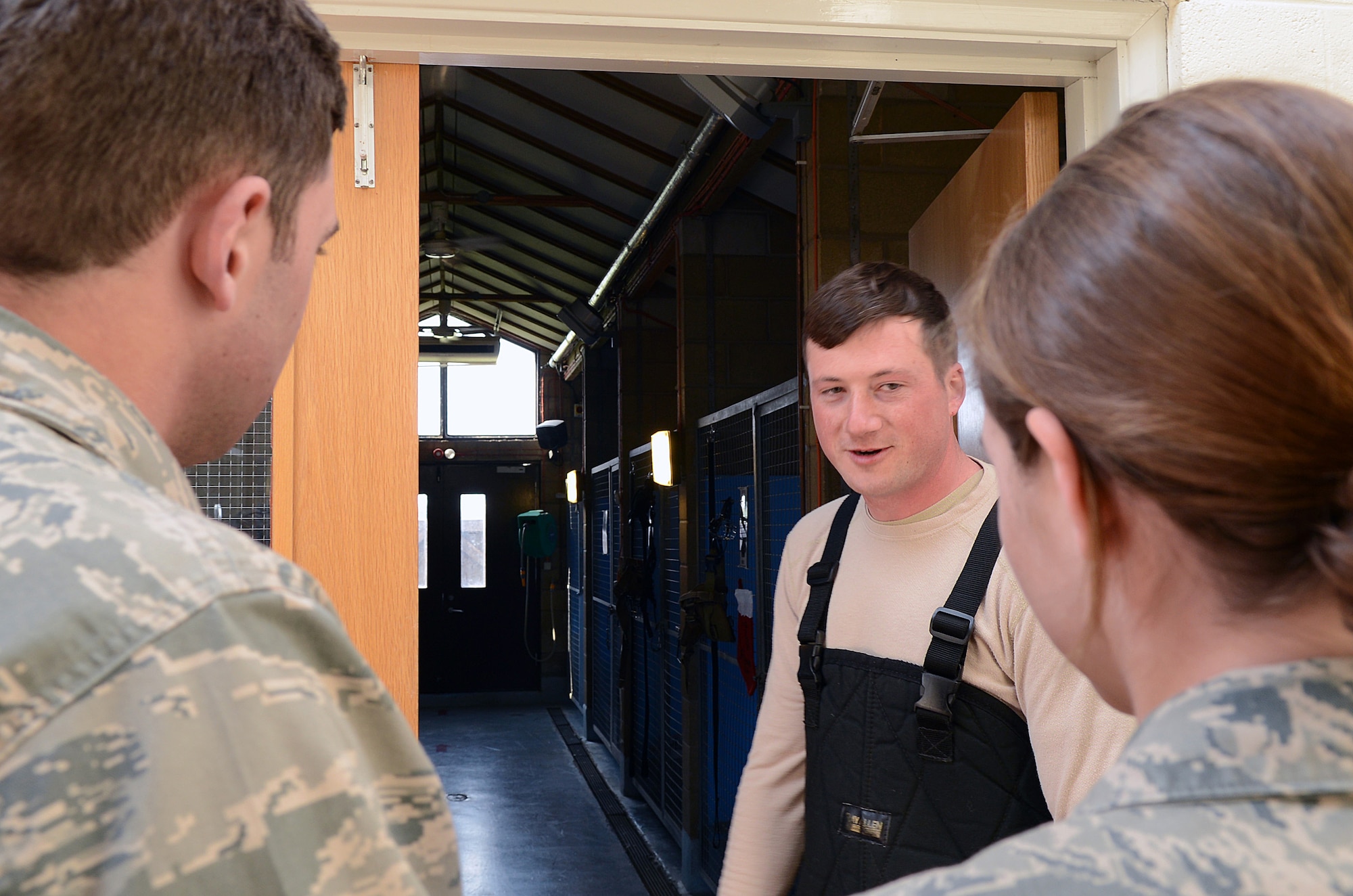 U.S. Air Force Staff Sgt. Barret Chappelle, 100th Security Forces Squadron Military Working Dog trainer from Lafayette, La., gives U.S. Air Force Academy cadets a tour of the MWD kennel facility March 25, 2014, on RAF Mildenhall, England. The cadets visited RAF Mildenhall and RAF Lakenheath during the academy’s spring break to get hands on experience in different career fields they are interested in joining. The cadets are scheduled to graduate in 2015. (U.S. Air Force photo by Airman 1st Class Jonathan Light/Released)