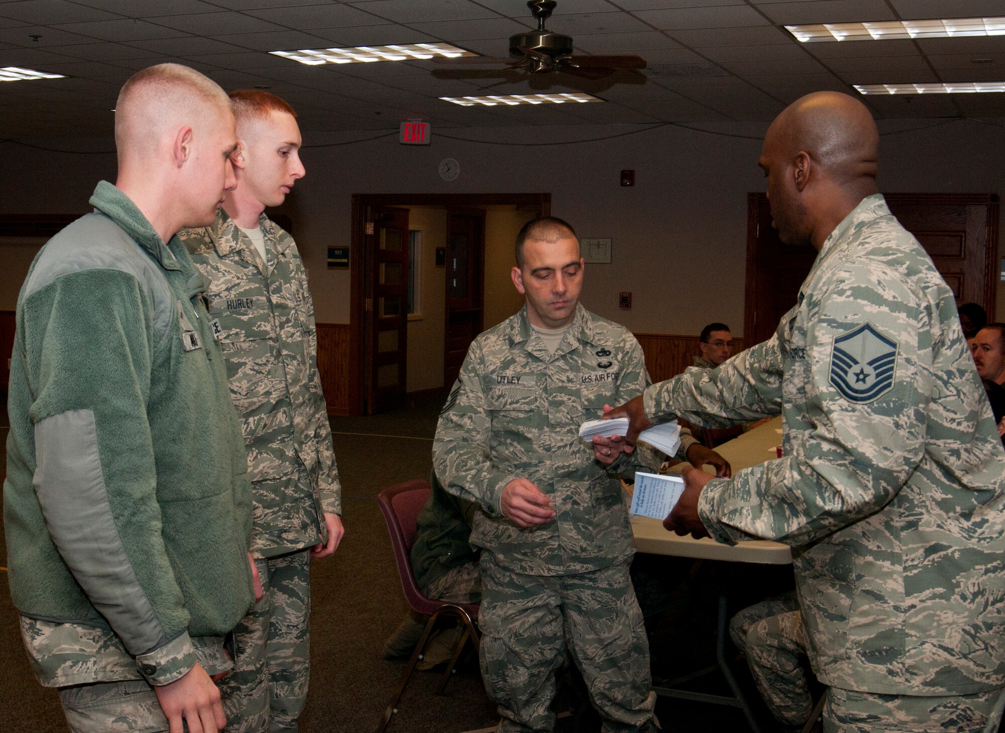 Master Sgt. Bertram Green, 90th Missile Wing Air Force Assistance Fund project officer and 90th Communications Squadron first sergeant, gives 90th Logistics Readiness Squadron AFAF representatives AFAF donation forms in the Chapel Activity Center March 21, 2014. Organization representatives received a briefing about the AFAF and instructions to help people within their respective organizations donate. (Air Force photo by Airman 1st Class Jason Wiese)