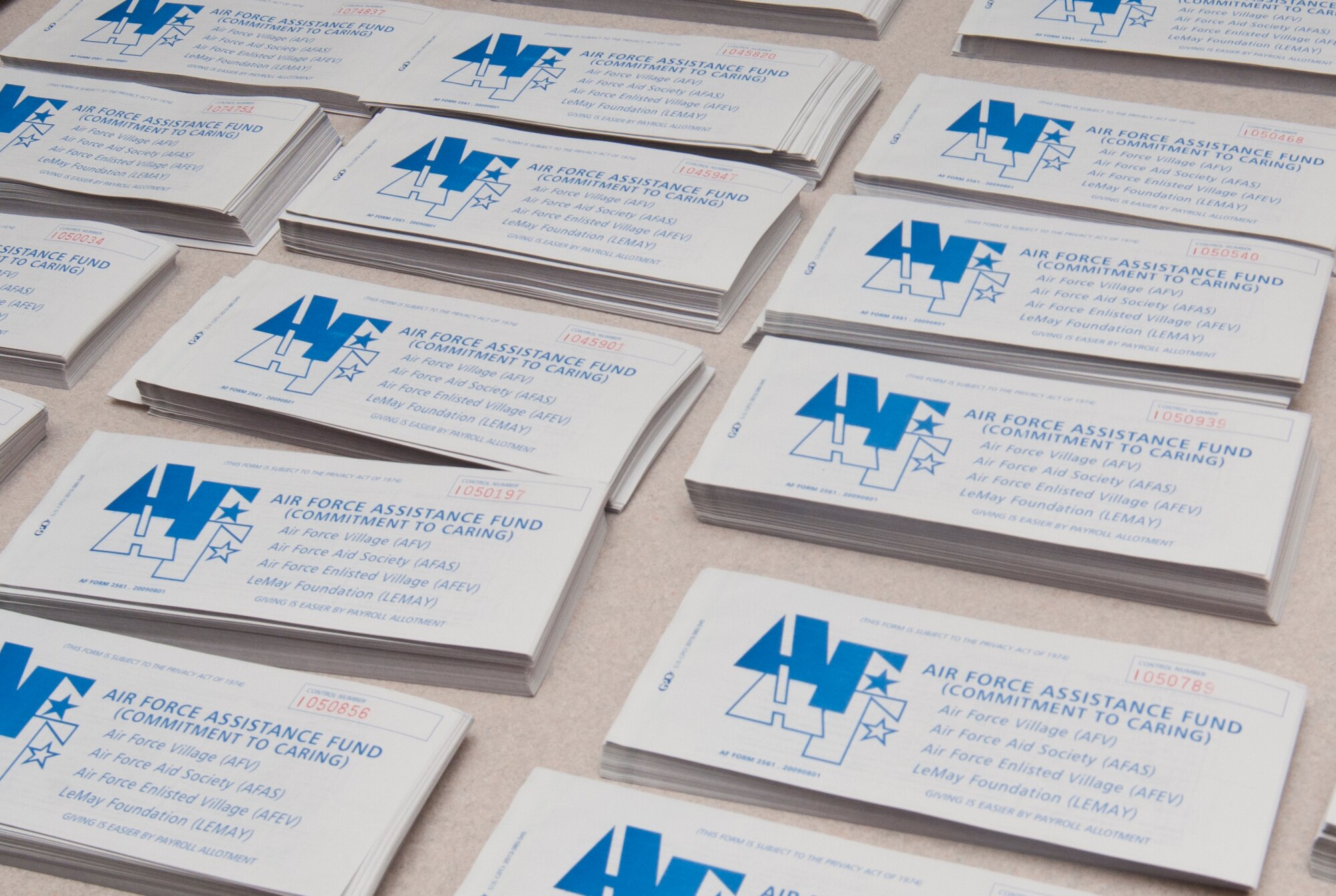 Stacks of Air Force Assistance Fund donation forms await distribution to the 90th Missile Wing organizations’ AFAF representatives in the Chapel Activity Center March 21, 2014. These forms allow Airmen to donate to charities that help Airmen in need. (Air Force photo by Airman 1st Class Jason Wiese)