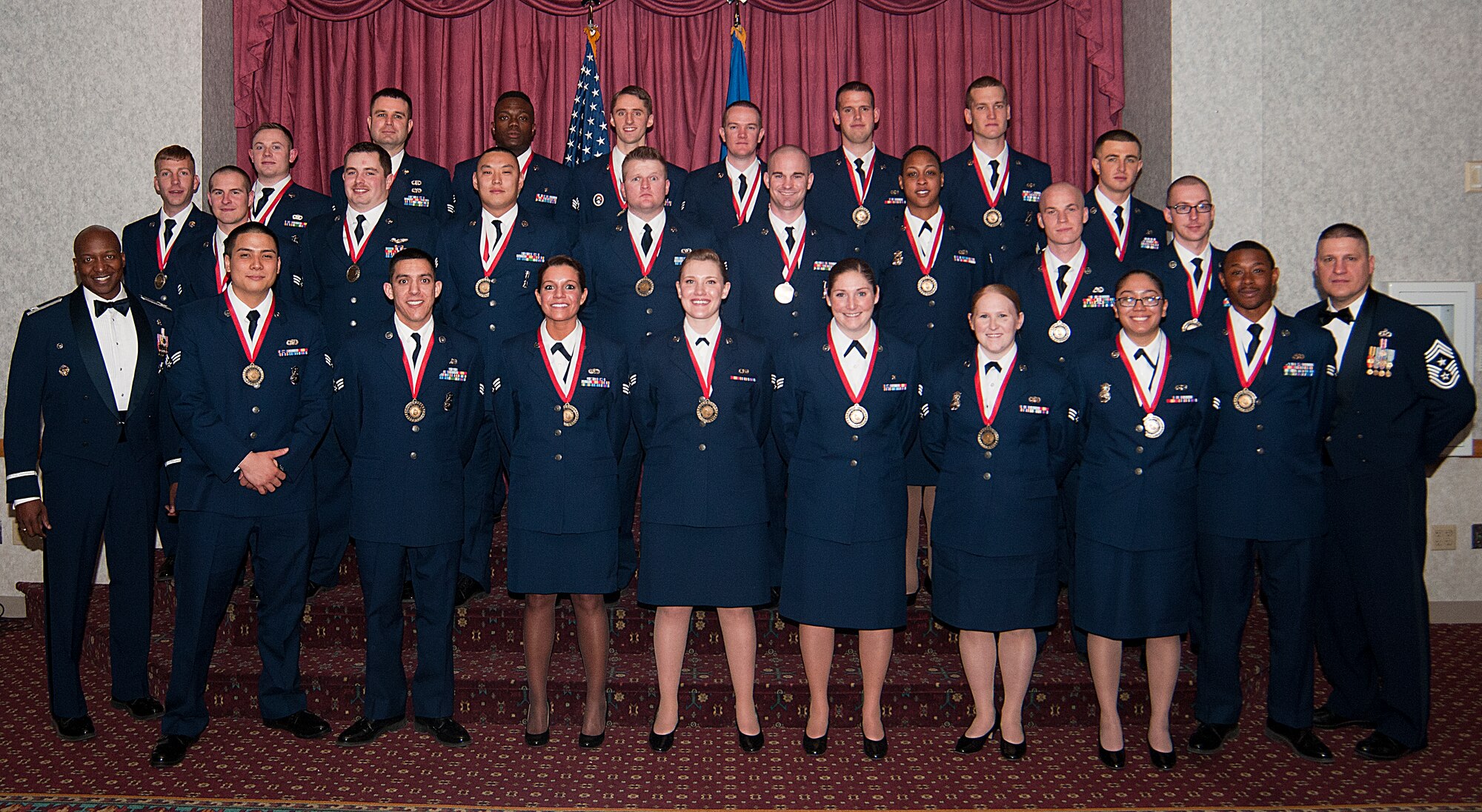 Airman Leadership School graduates from Class 14-D pose for a group photo on the stage in the Trail’s End Club on F.E. Warren Air Force Base, Wyo., after their graduation ceremony March 26, 2014. ALS students undergo professional military training in leadership, and the training is required for an Airman to become supervisors. (U.S. Air Force photo by Airman 1st Class Jason Wiese)