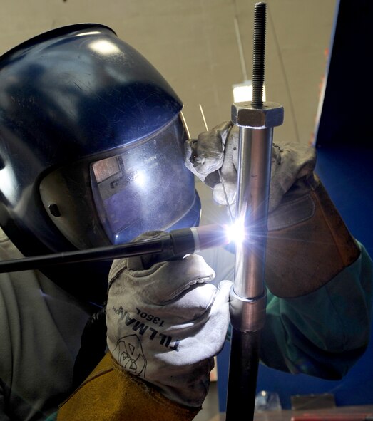 Senior Airman Tony Guinn, 2nd Maintenance Squadron aircraft metals technology journeyman, tungsten inert gas, or TIG, welds an aluminum tube mounted on a 45 degree fixture on Barksdale Air Force Base, La., March. 25, 2014. These tubes are part of a five-year welder’s certification. The certification requires a steady hand to ensure proper weld penetration through the walls of the aluminum. (U.S. Air Force photo/Staff Sgt. Jason McCasland)