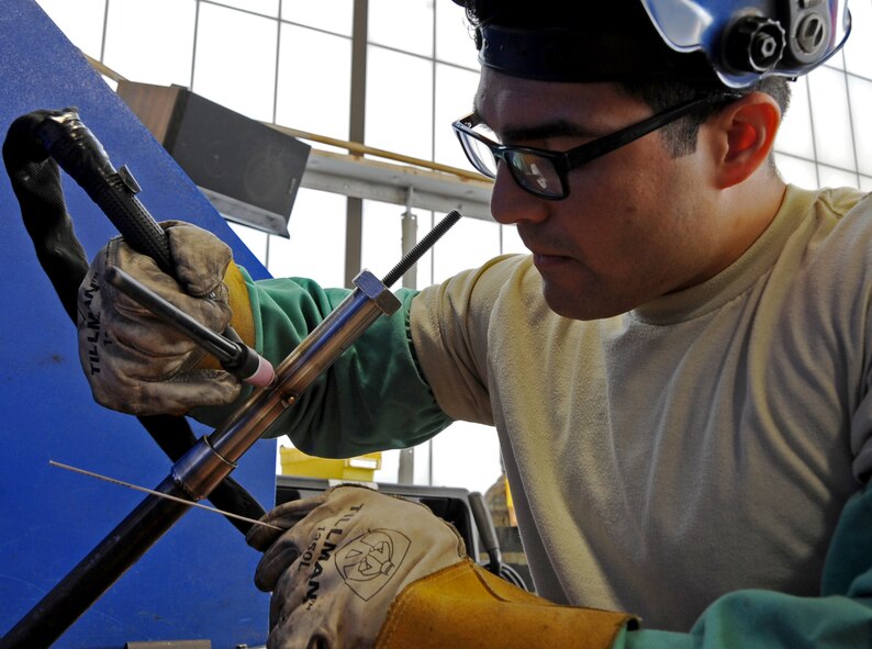 Senior Airman Tony Guinn, 2nd Maintenance Squadron aircraft metals technology journeyman, welds two aluminum tubes as part of his five-year certification on Barksdale Air Force Base, La., March. 25, 2014. The certification requires two pieces of aluminum to be mounted on a fixture at 45 degrees and welded. (U.S. Air Force photo/Staff Sgt. Jason McCasland)