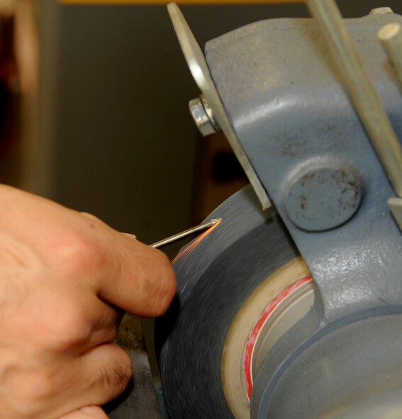 Senior Airman Tony Guinn, 2nd Maintenance Squadron aircraft metals technology journeyman, grinds a tungsten inert gas, or TIG, welder tip prior to his welding certification on Barksdale Air Force Base, La., March. 25, 2014. The certification requires two pieces of aluminum to be mounted on a fixture at 45 degrees and cannot be repositioned once mounted. (U.S. Air Force photo/Staff Sgt. Jason McCasland)