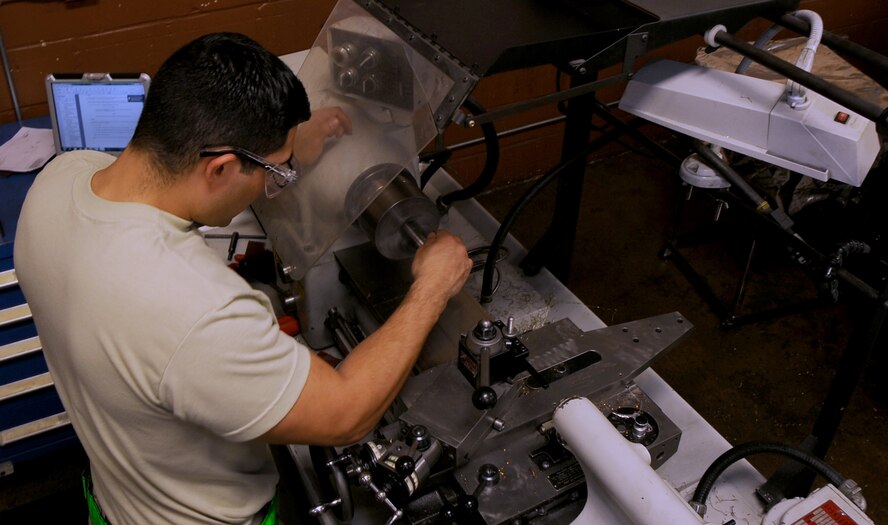 Senior Airman Tony Guinn, 2nd Maintenance Squadron aircraft metals technology journeyman, uses a lathe to de-burr a pipe prior to welding on Barksdale Air Force Base, La., March.25, 2014. Prior to becoming a certified welder, each Airmen must clean their parts to be welded to ensure proper weld fusion. (U.S. Air Force photo/Staff Sgt. Jason McCasland)