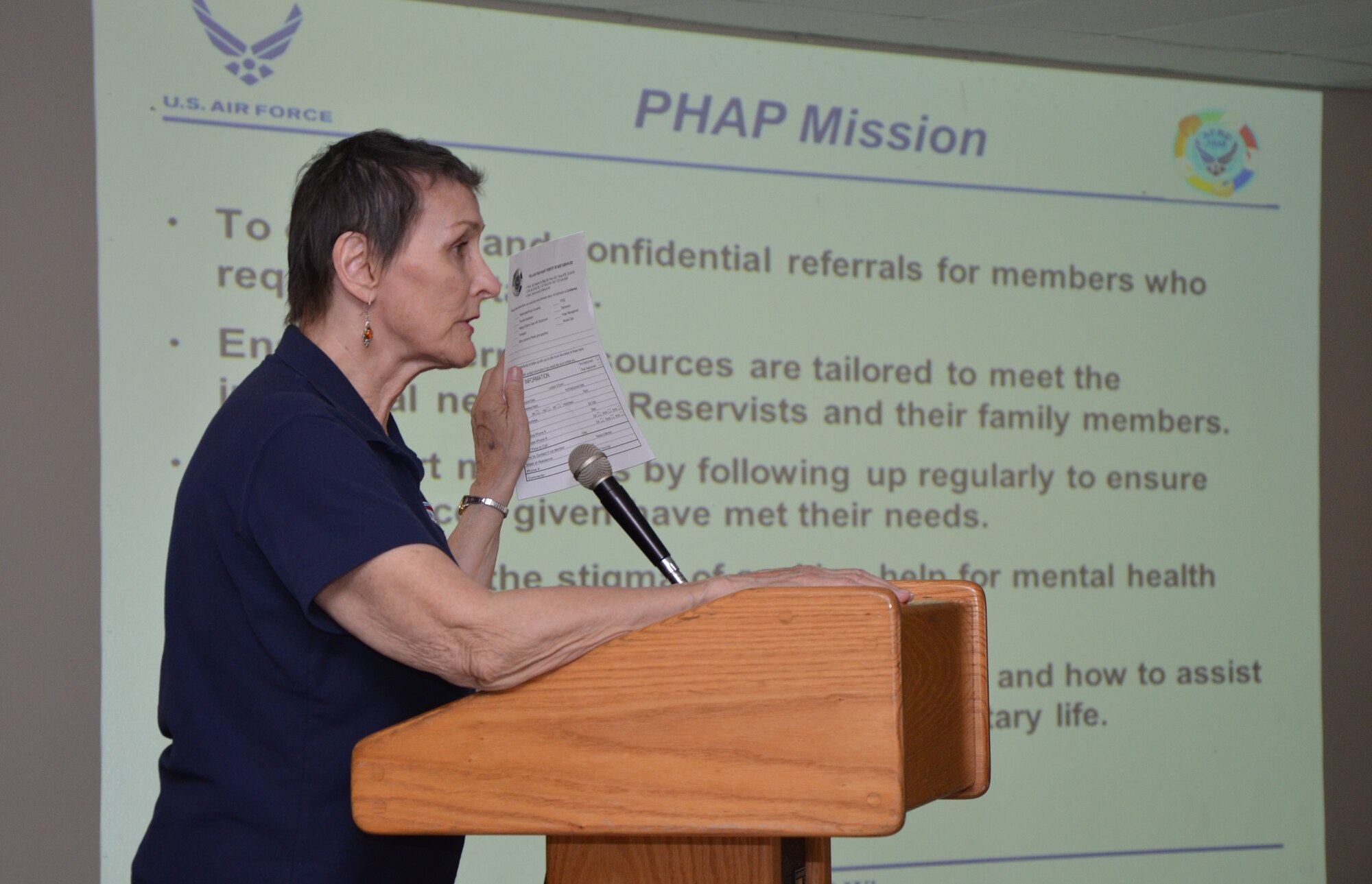 Karen Orcutt, a case facilitator for the Air Force Reserve Command's Psychological Health Advocacy Program (PHAP), holds up a contact sheet for 624th Regional Support Group reservists to fill out if they are interested in being contacted by her office about specific resources available to them and their families, Joint Base Pearl Harbor-Hickam, Hawaii, Mar. 9, 2014. The PHAP briefing was held during the 624th RSG's commander's call in order to inform all unit members of these free mental health resources regardless of deployment status. (U.S. Air Force photo by Tech. Sgt. Phyllis Keith)