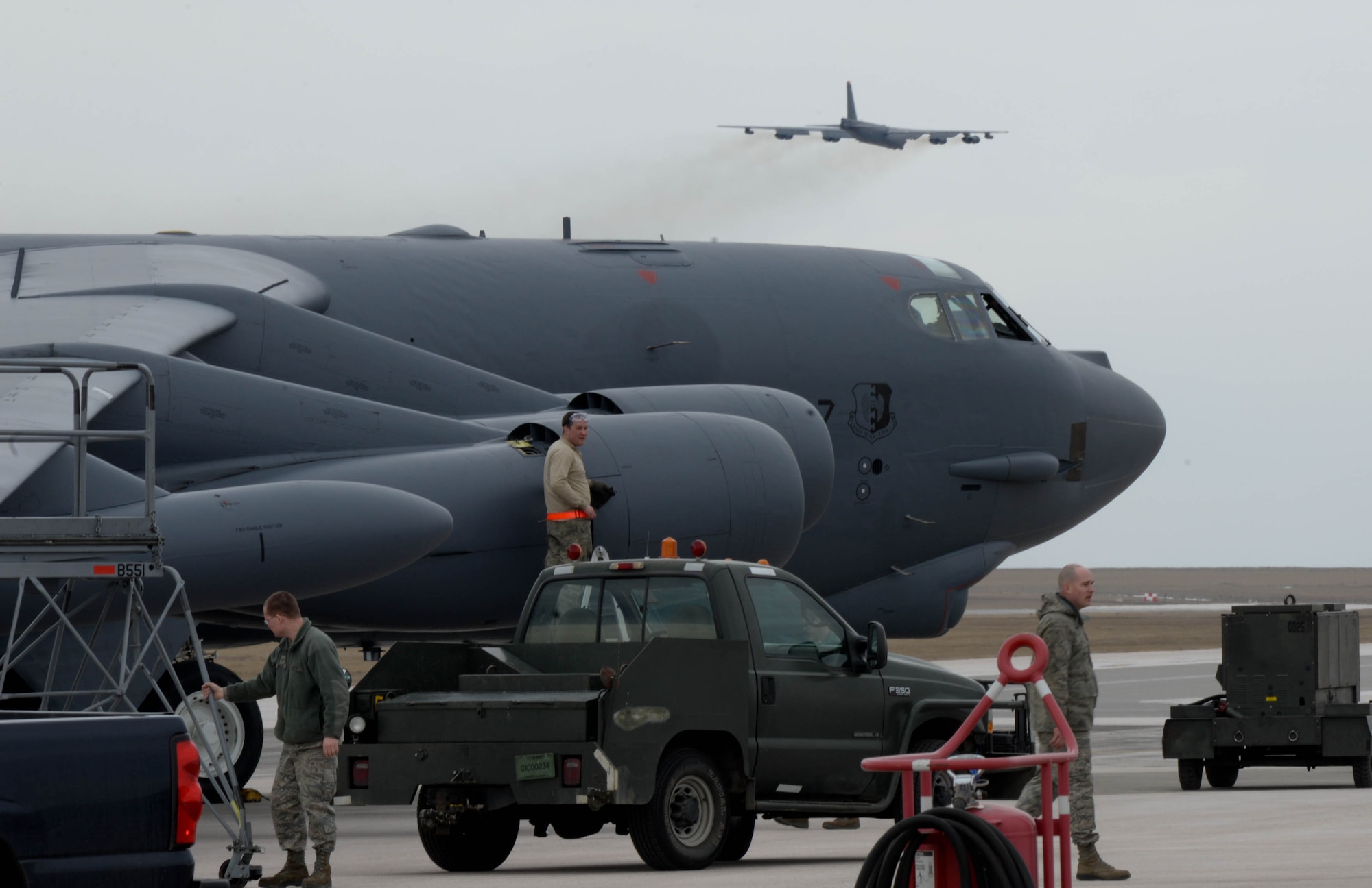 Airmen from the 5th Maintenance Squadron at Minot Air Force Base, N.D., work on a B-52 at Ellsworth AFB, S.D., March 26, 2014. Due to an ongoing runway repair at Minot, several B-52 aircraft and 300 Airmen will be on temporary duty at Ellsworth for six months to continue combat operations until repairs are complete. (U.S. Air Force photo by Senior Airman Zachary Hada/Released)