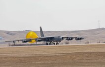 A B-52H Stratofortress from the 5th Bomb Wing at Minot Air Force Base, N.D., deploys a parachute after landing at Ellsworth AFB, S.D., March 26, 2014. More than 300 Airmen and eight bombers from Minot will be temporarily operating out of Ellsworth during a runway repair project at their base. (U.S. Air Force photo by Senior Airman Zachary Hada/Released)