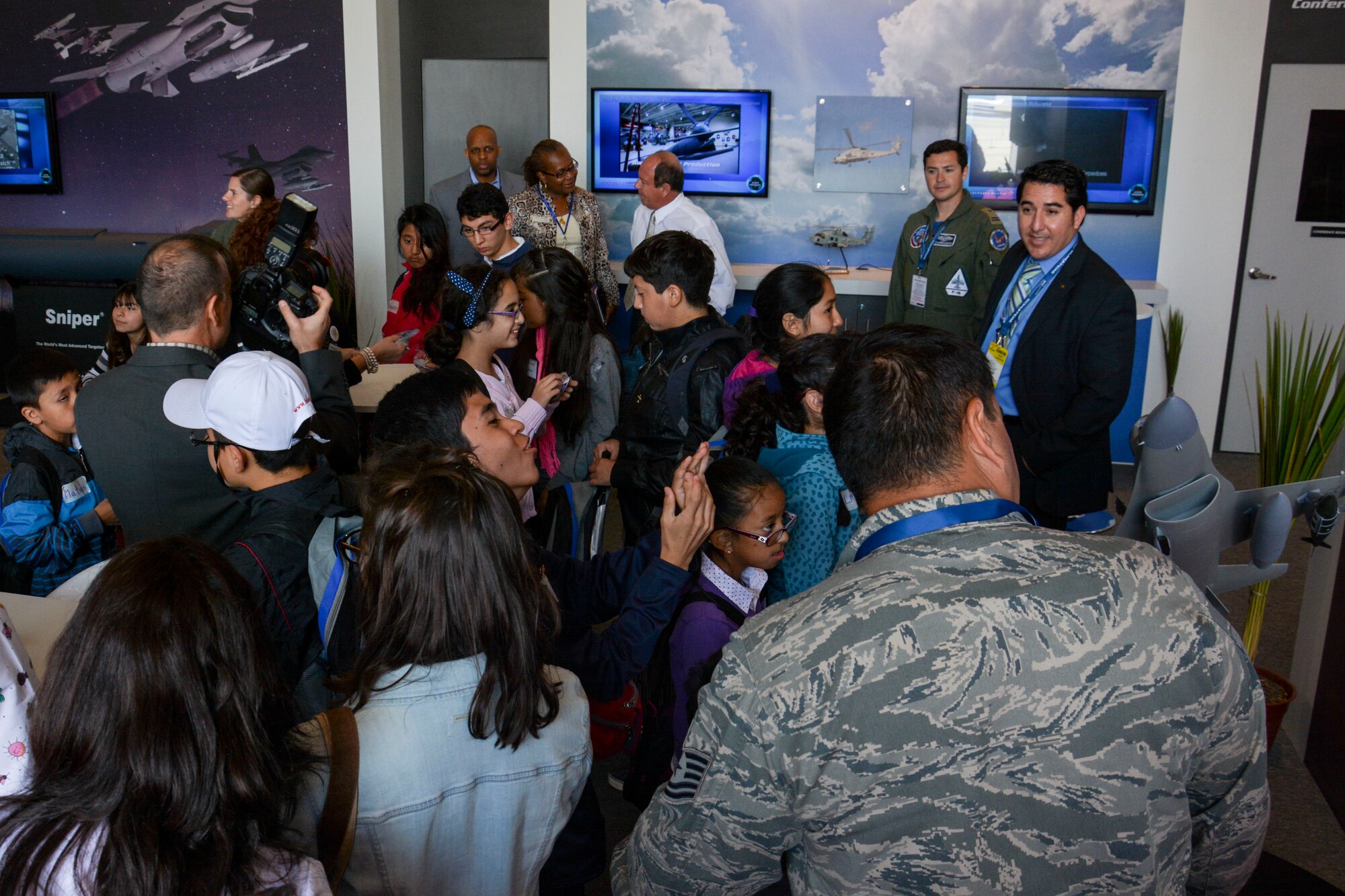 Chilean children from the Make-A-Wish and Telet?n Foundations get a tour of the U.S. pavilion at the FIDAE Air Show in Santiago, Chile, March 26. Nearly 60 U.S. airmen are participating in subject matter expert exchanges with Chilean air force counterparts during FIDAE, and as part of the events are hosting static displays of the C-130 Hercules and F-16 Fighting Falcon. Airmen from the Texas Air National Guard set aside time to host the children before the public days of FIDAE, which are scheduled for the weekend. (U.S. Air Force photo by Capt. Justin Brockhoff/Released)