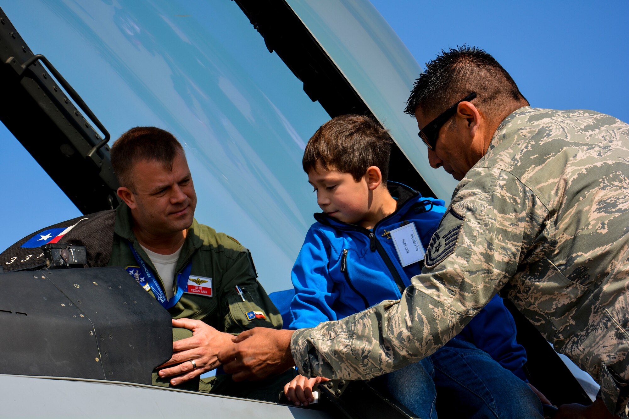 A Chilean boy from the Telet?n Foundation gets an up-close view inside a U.S. F-16 Fighting Falcon and discusses the aircraft with Maj. Scott Elrod, an F-16 pilot, and Master Sgt. Carlos Rodriguez, an F-16 maintenance specialist, at the FIDAE Air Show in Santiago, Chile, March 26. Nearly 60 U.S. airmen are participating in subject matter expert exchanges with Chilean air force counterparts during FIDAE, and as part of the events are hosting static displays of the C-130 Hercules and F-16. Airmen from the Texas Air National Guard set aside time to host the children before the public days of FIDAE, which are scheduled for the weekend. (U.S. Air Force photo by Capt. Justin Brockhoff/Released)